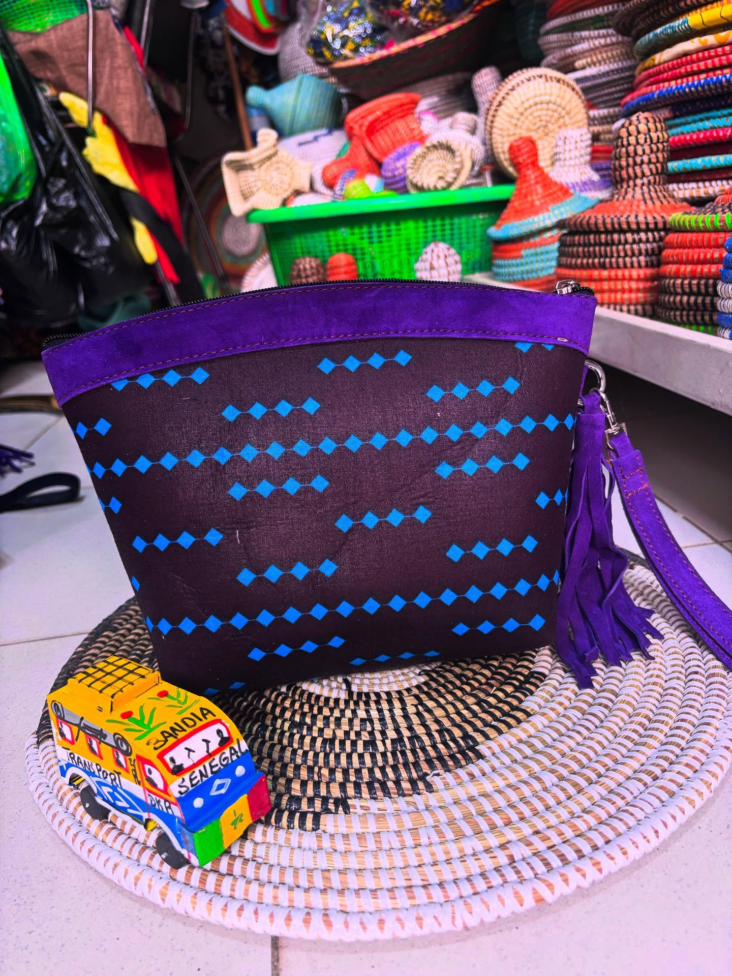 Pochette en tissu à motifs bleus et cuir violet avec pompon
