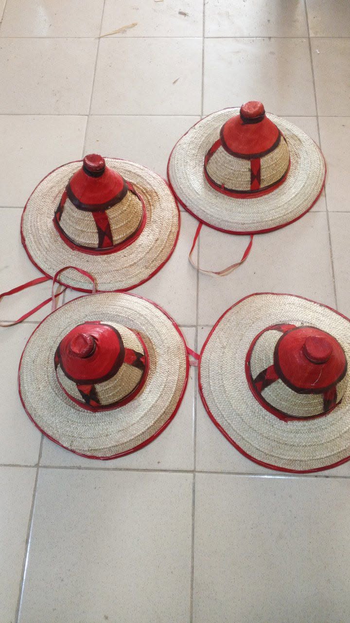 Quatre chapeaux en paille tressée bordés de cuir rouge